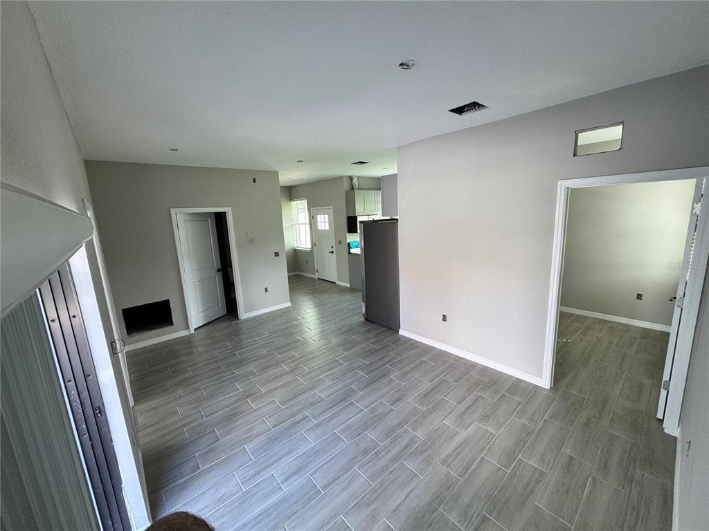 101 Grove Street Orlando, FL 32835 - Photo 17 of 57 wooden floor in an empty room with a window
