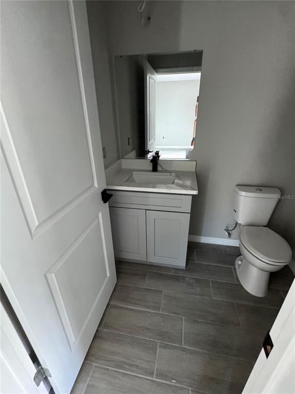 101 Grove Street Orlando, FL 32835 - Photo 18 of 57 a bathroom with a toilet sink and mirror