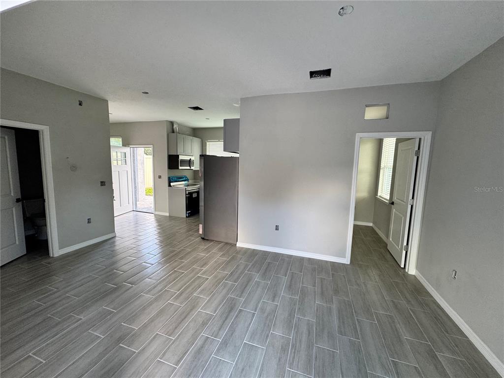 101 Grove Street Orlando, FL 32835 - Photo 21 of 57 a view of a big room with wooden floor and a window