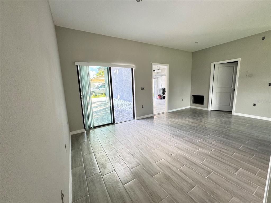 101 Grove Street Orlando, FL 32835 - Photo 22 of 57 a view of an empty room with window and wooden floor