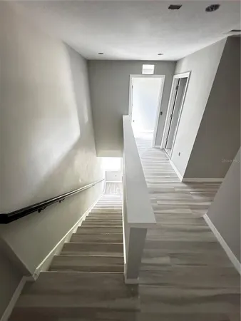 a view of a room with wooden floor and staircase