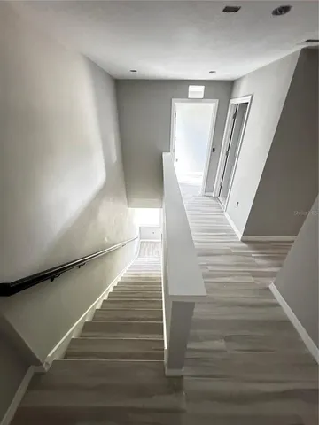a view of a room with wooden floor and staircase