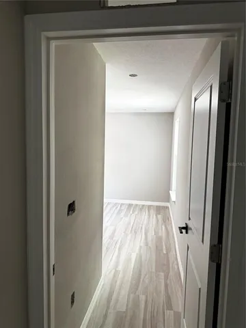 a view of a room with wooden floor and window