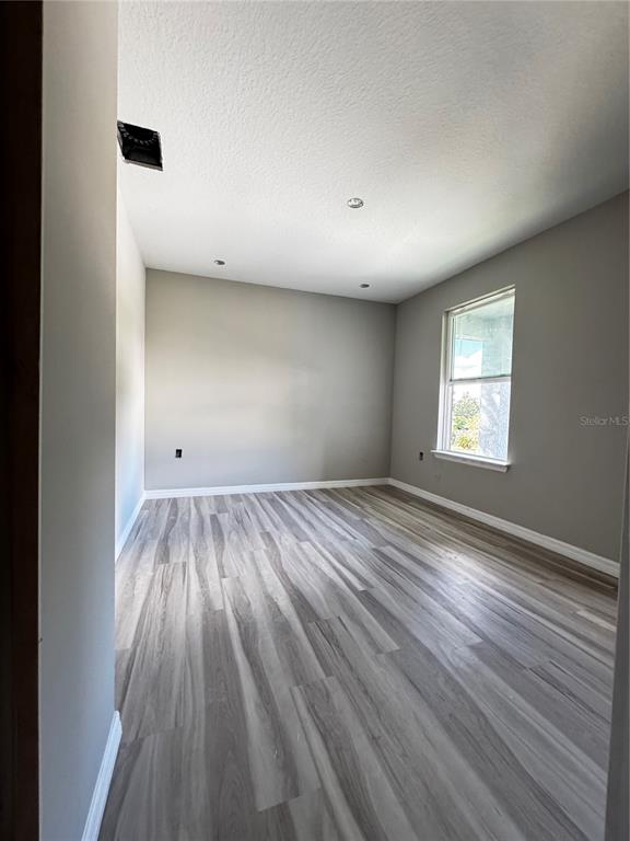 101 Grove Street Orlando, FL 32835 - Photo 27 of 57 an empty room with wooden floor and windows