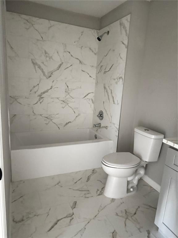 101 Grove Street Orlando, FL 32835 - Photo 31 of 57 a white toilet sitting next to a bath tub and a shower