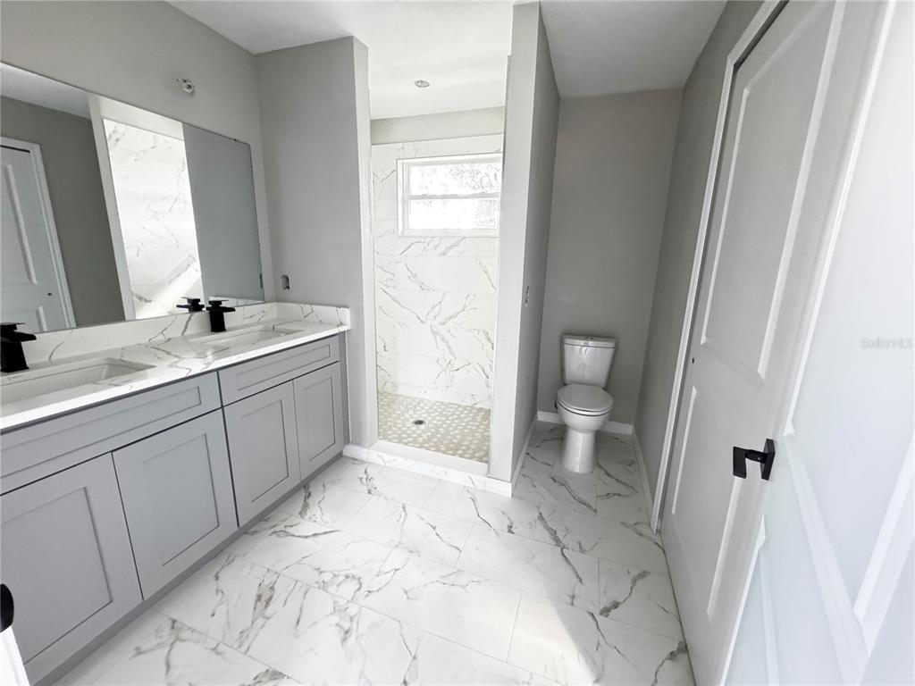 101 Grove Street Orlando, FL 32835 - Photo 45 of 57 a bathroom with a sink toilet and shower