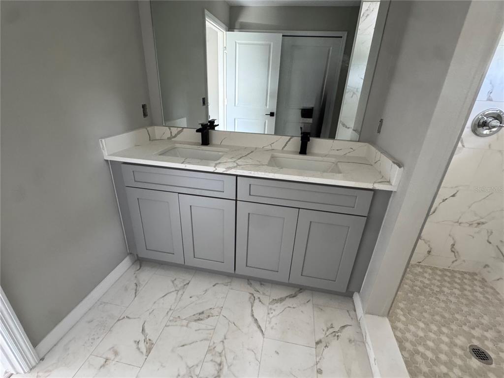 101 Grove Street Orlando, FL 32835 - Photo 47 of 57 a bathroom with a sink and a mirror