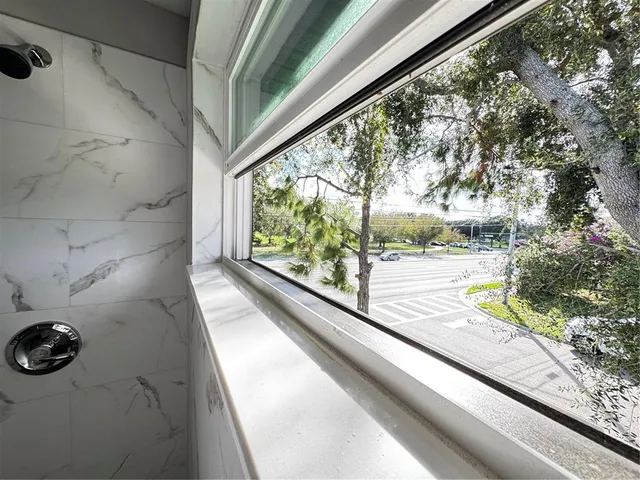 a view of a patio with a table and chairs under an umbrella