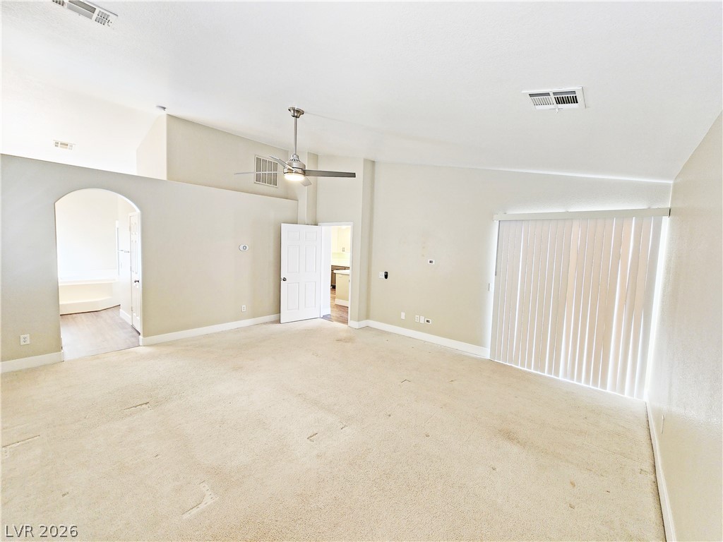 4591 Stoneham Street Pahrump, NV 89061 - Photo 24 of 42 A spacious room offers comfortable carpet flooring and vaulted ceilings, ready for personal touches.