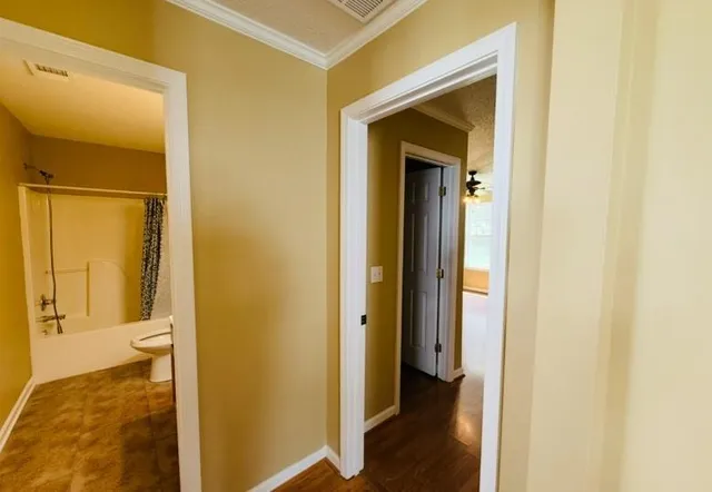 a view of a bathroom from a hallway