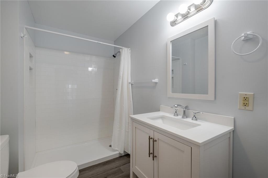 108 Reeves Lane Elkin, NC 28621 - Photo 14 of 20 Remodeled bathroom features new vanity, lighting, shower and commode.