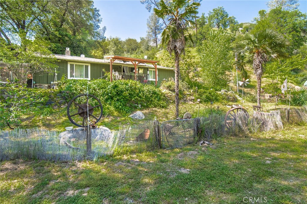 10049 Incline Road El Portal, CA 95318 - Photo 18 of 44 a backyard of a house with lots of green space and lake view