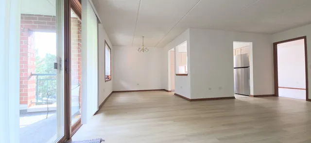 a view of a livingroom with wooden floor and a window