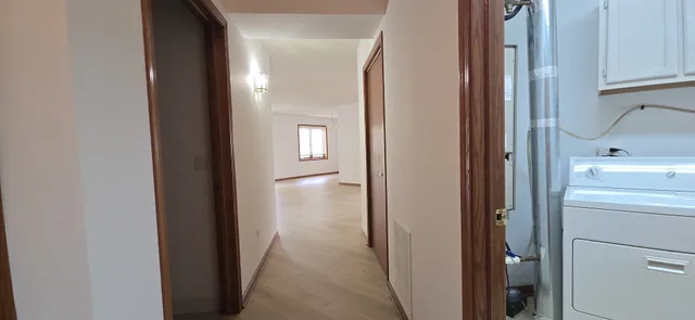 a view of a hallway with two rooms