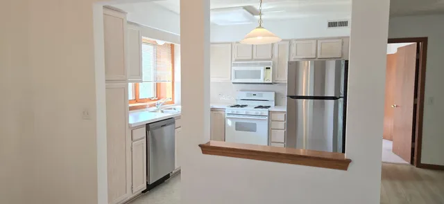 a kitchen with cabinets and stainless steel appliances