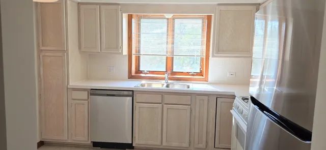a kitchen with granite countertop white cabinets and white appliances