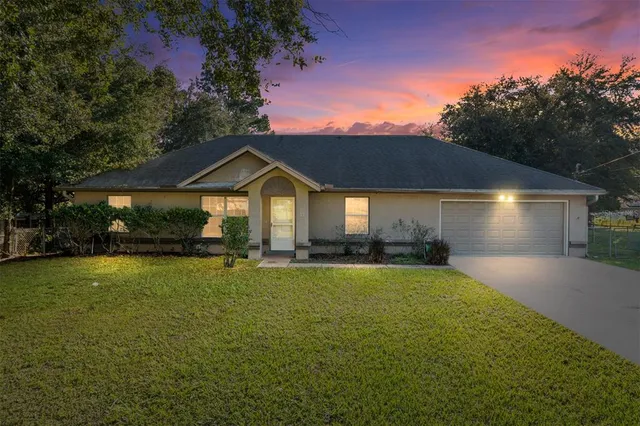 a front view of a house with a garden and patio