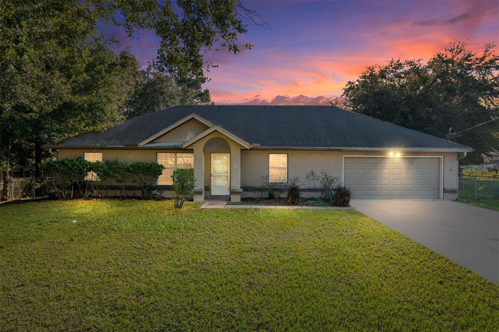 21 Pecan Course Circle Ocala, FL 34472 - Photo 1 of 46 a front view of a house with a garden and patio