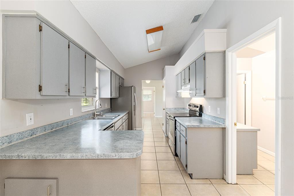 21 Pecan Course Circle Ocala, FL 34472 - Photo 15 of 46 a kitchen with stainless steel appliances granite countertop a sink stove and cabinets