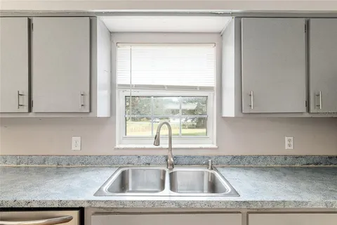 a kitchen with a sink and cabinets