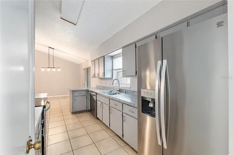 a kitchen with stainless steel appliances a refrigerator sink and cabinets