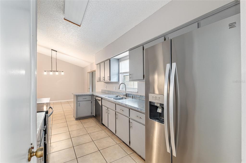 21 Pecan Course Circle Ocala, FL 34472 - Photo 19 of 46 a kitchen with stainless steel appliances a refrigerator sink and cabinets