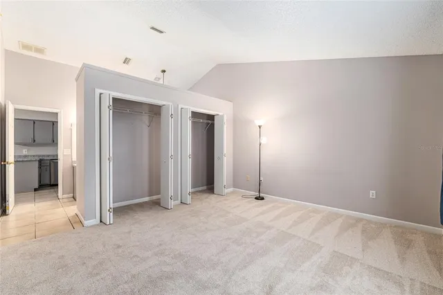 an empty room with closet and a bathroom