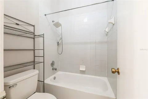 a bathroom with a granite countertop shower