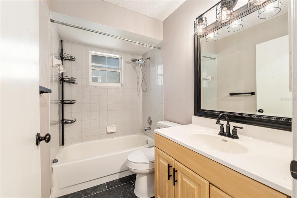 21 Pecan Course Circle Ocala, FL 34472 - Photo 30 of 46 a bathroom with a sink a toilet a mirror a bathtub and shower