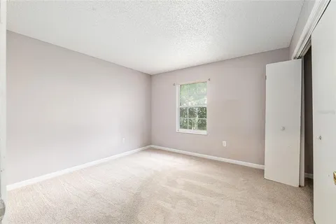 an empty room with windows and closet