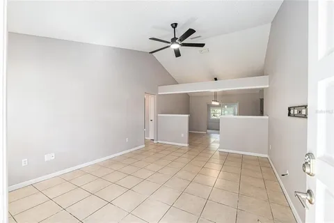 a view of a livingroom with a ceiling fan and wooden floor