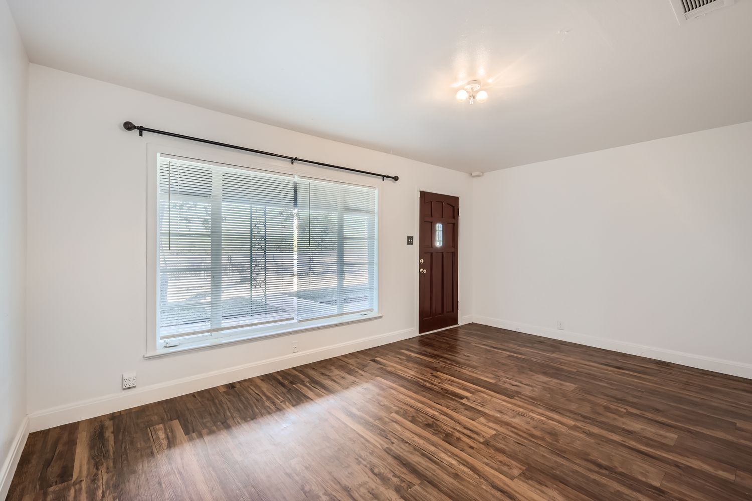 7348 Highway 183 Lockhart, TX 78644 - Photo 11 of 13 Empty room featuring baseboards and dark wood-style flooring