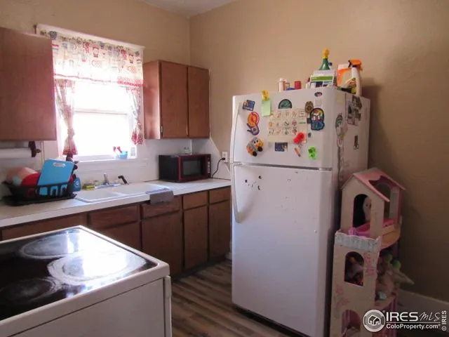 a room with a refrigerator and window