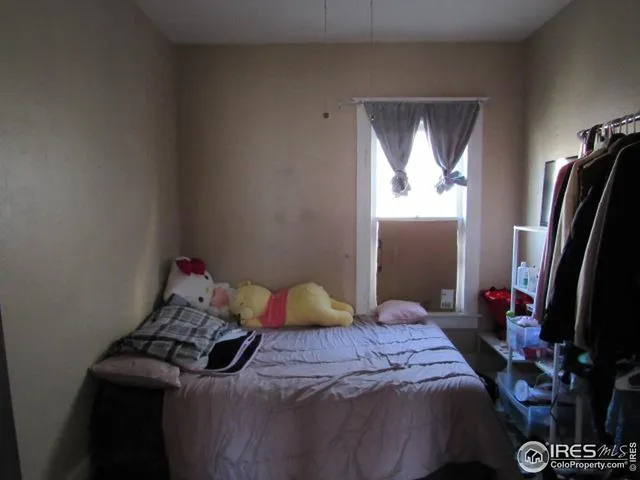 a bedroom with a bed and a potted plant