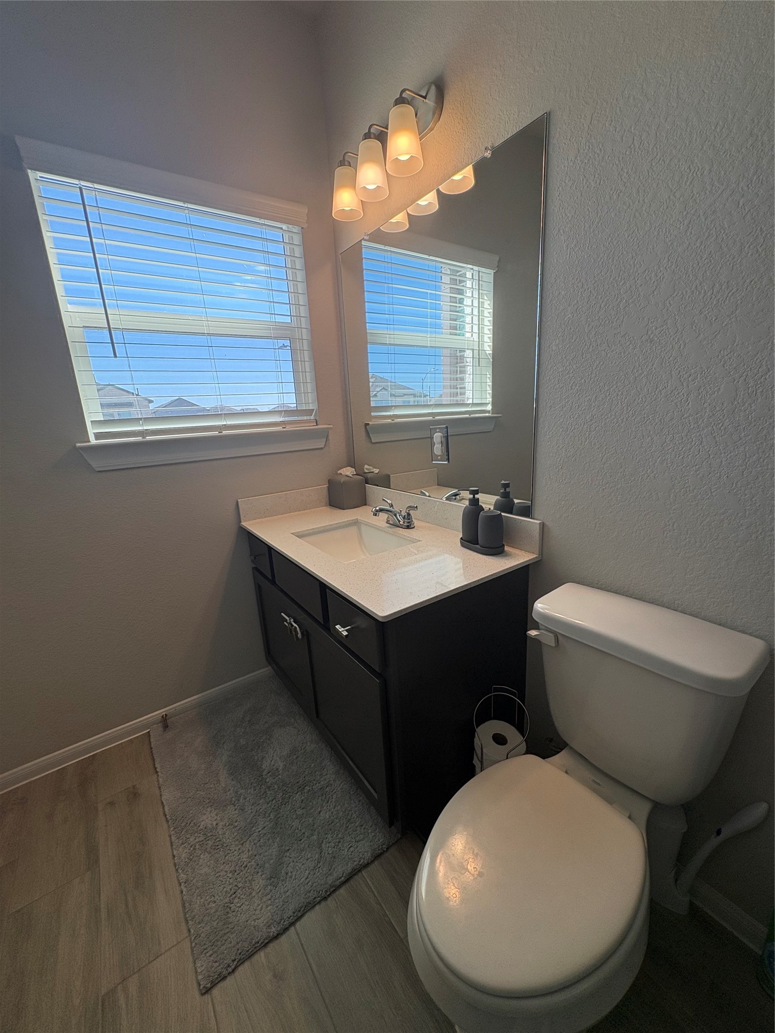 1239 Marvista Lane Rosharon, TX 77583 - Photo 39 of 50 a bathroom with a toilet sink and mirror