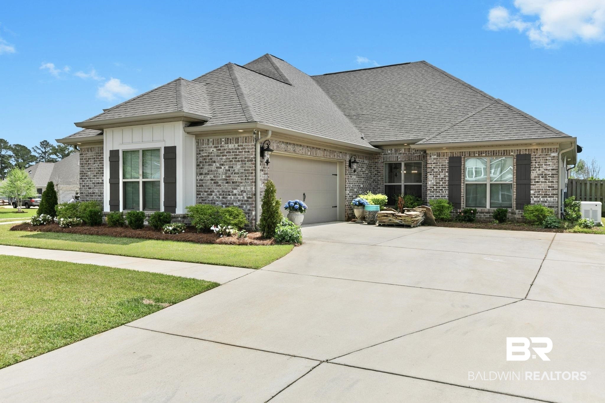 291 Hemlock Drive Fairhope, AL 36532 - Photo 4 of 65 View of front of home featuring brick siding, driveway, an attached garage, roof with shingles, and a front lawn