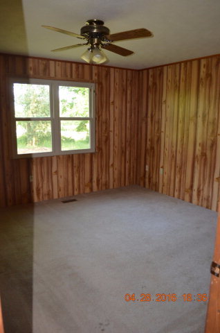 4684 Fulton Mill Road Macon, GA 31216 - Photo 11 of 16 an empty room with a window and a ceiling fan