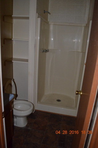 4684 Fulton Mill Road Macon, GA 31216 - Photo 12 of 16 a bathroom with a toilet and a shower
