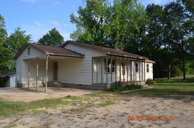4684 Fulton Mill Road Macon, GA 31216 - Photo 13 of 16 a front view of a house with a garden