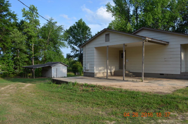 4684 Fulton Mill Road Macon, GA 31216 - Photo 14 of 16 a backyard of a house with table and chairs