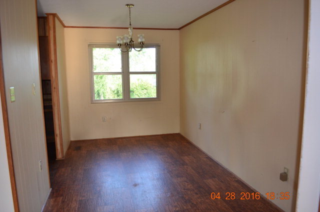 4684 Fulton Mill Road Macon, GA 31216 - Photo 3 of 16 an empty room with wooden floor and windows