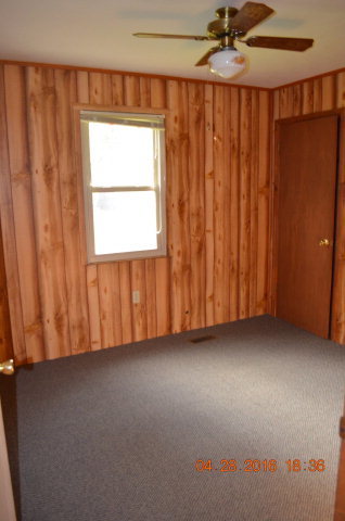 4684 Fulton Mill Road Macon, GA 31216 - Photo 9 of 16 an empty room with a window and a ceiling fan