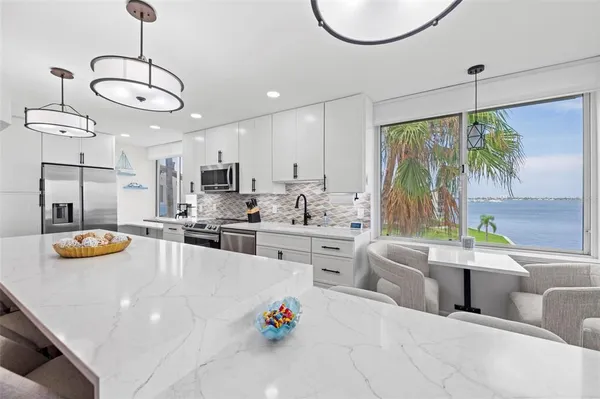 a large white kitchen with a large window