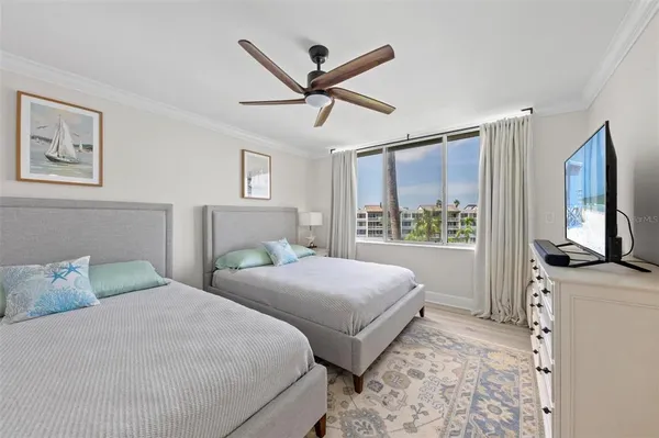 a bedroom with a bed window and television