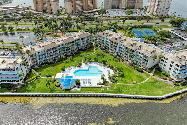 a view of swimming pool with a yard and large trees