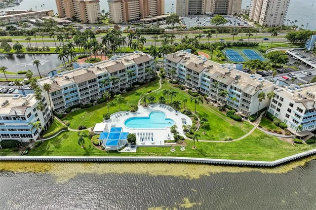 a view of swimming pool with a yard and large trees