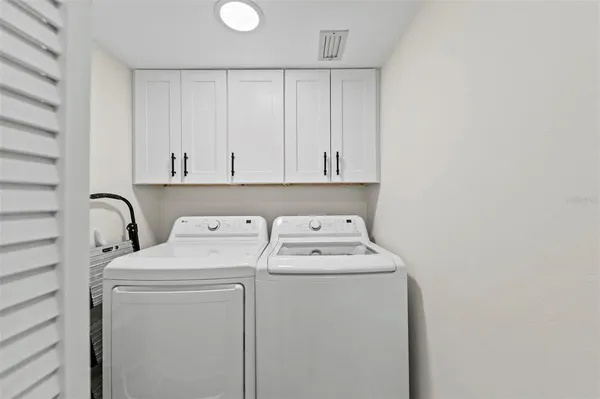 a view of a pathway both side of grassy field with shrub