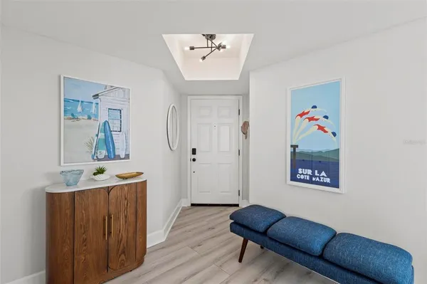 a hallway with furniture and wooden floor