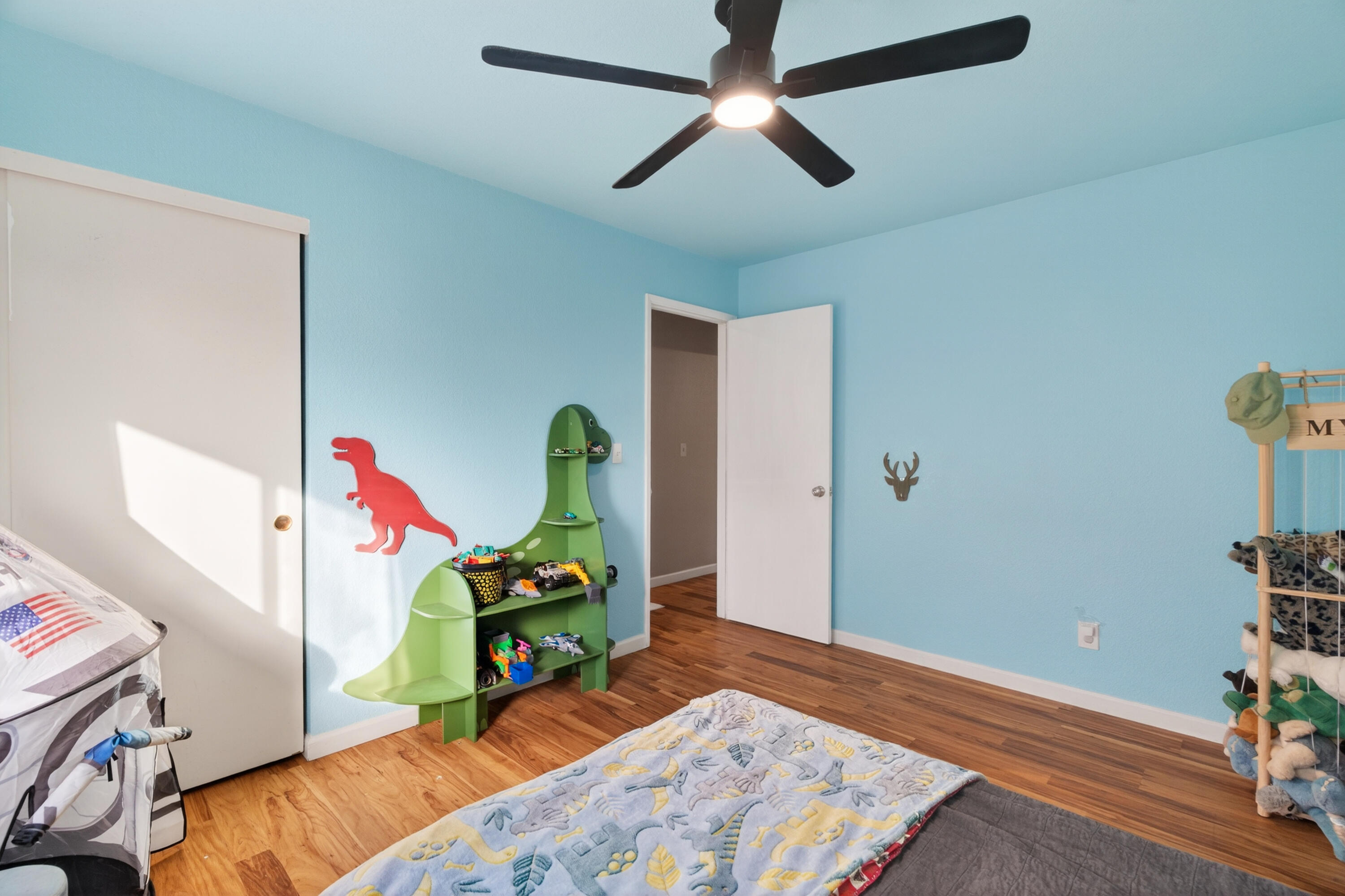 3733 Capricorn Way Redding, CA 96002 - Photo 11 of 22 a bedroom with a bed and wooden floor