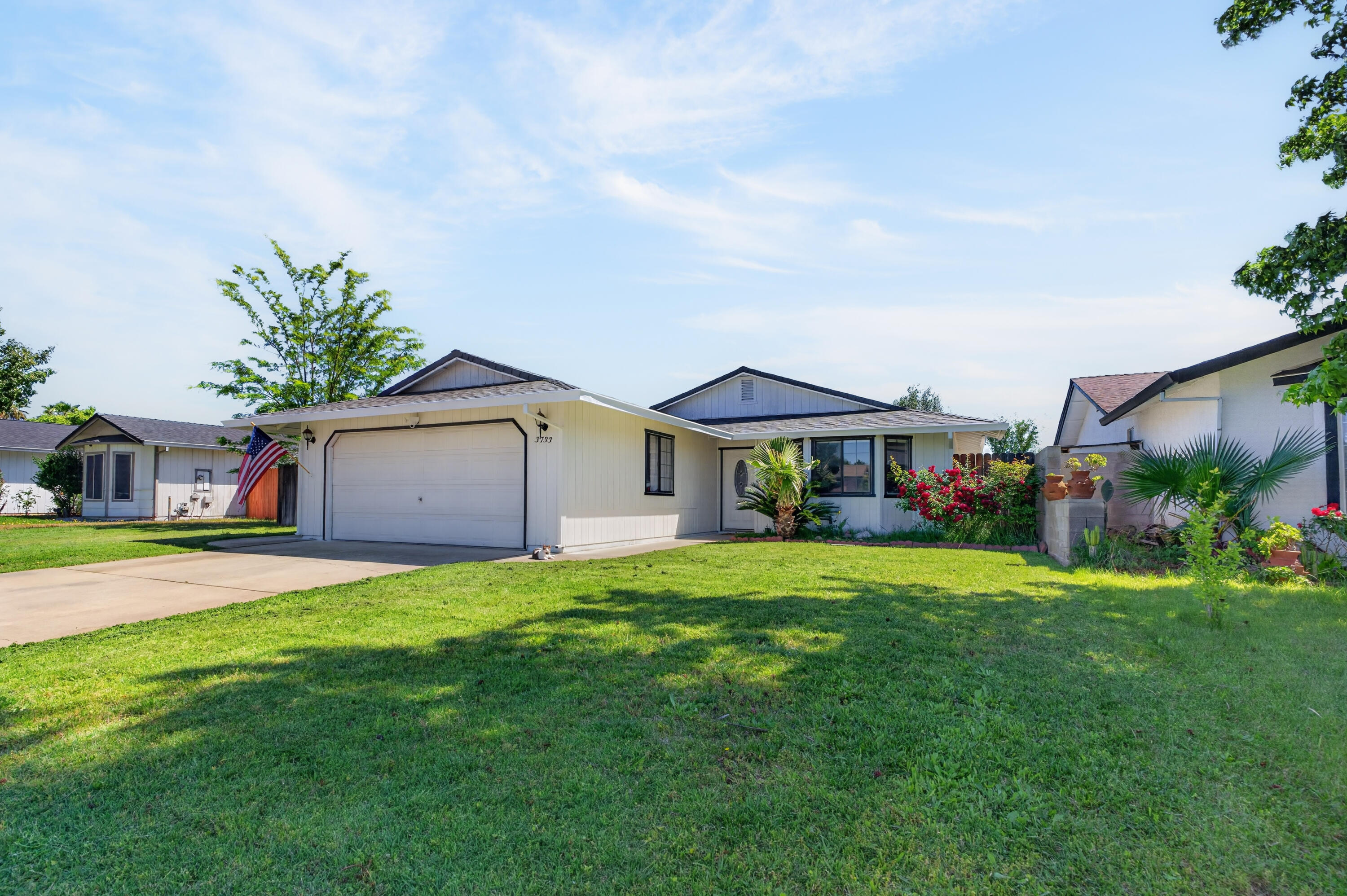 3733 Capricorn Way Redding, CA 96002 - Photo 2 of 22 a front view of a house with a garden and trees